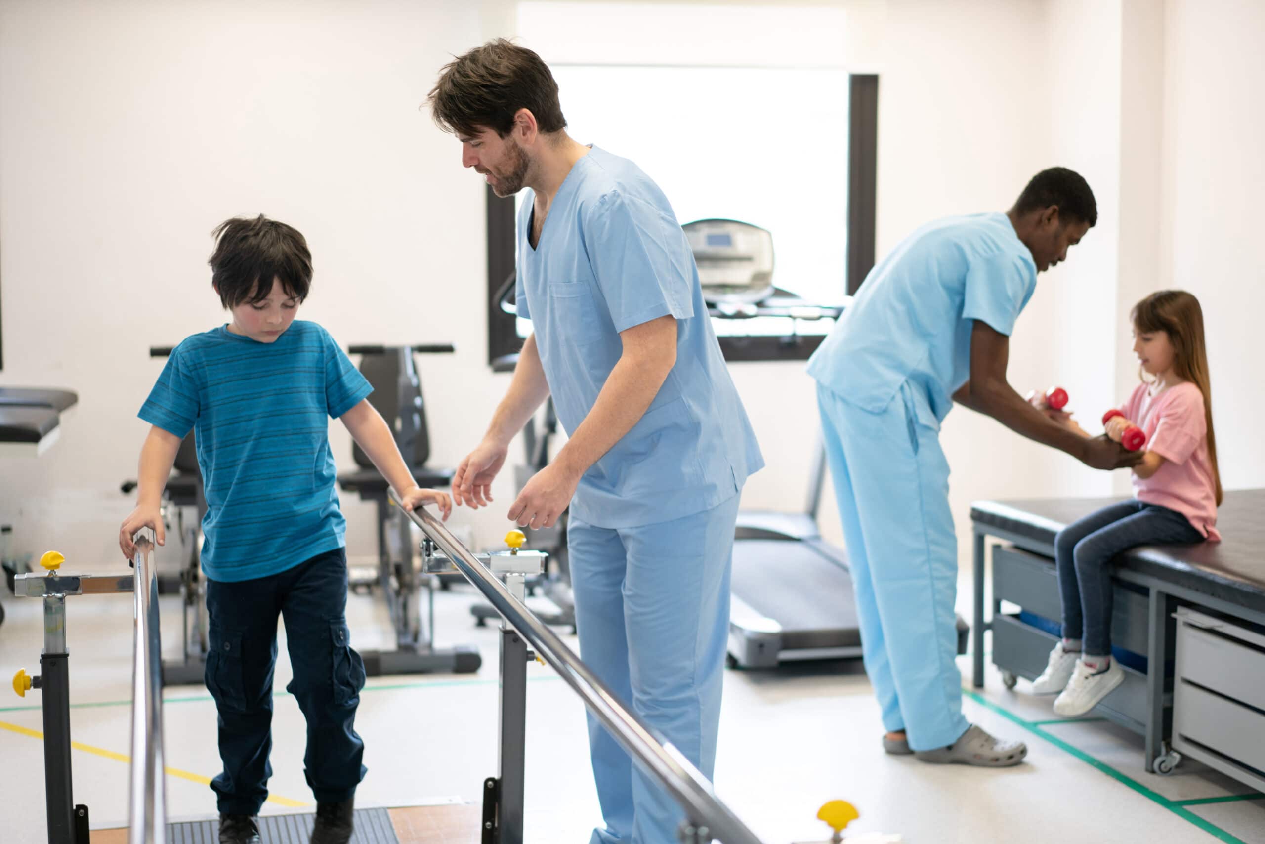 Kids during physical rehab each working with their physical therapist at the clinic